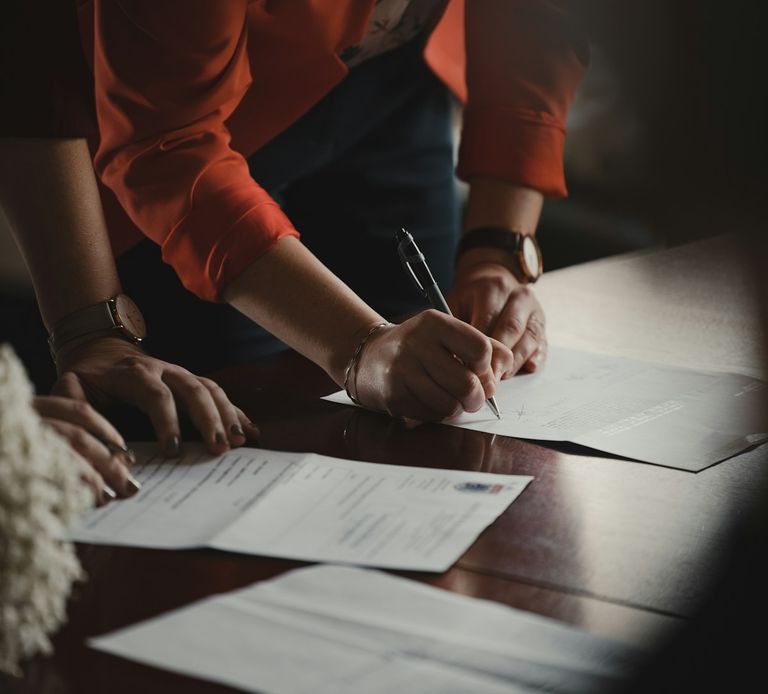 Divorcing couple signing real estate and legal documents